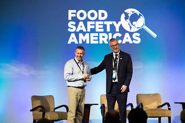 Andrew Clarke being presented the BRCGS CEO Award by Mark Proctor at Food Safety Americas 2019