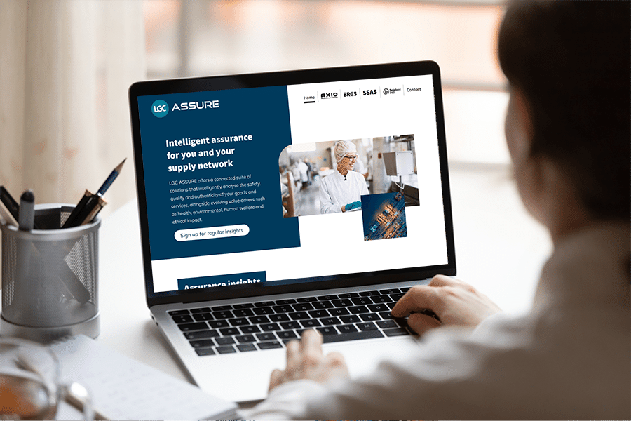 Person sat at computer looking at LGC ASSURE website